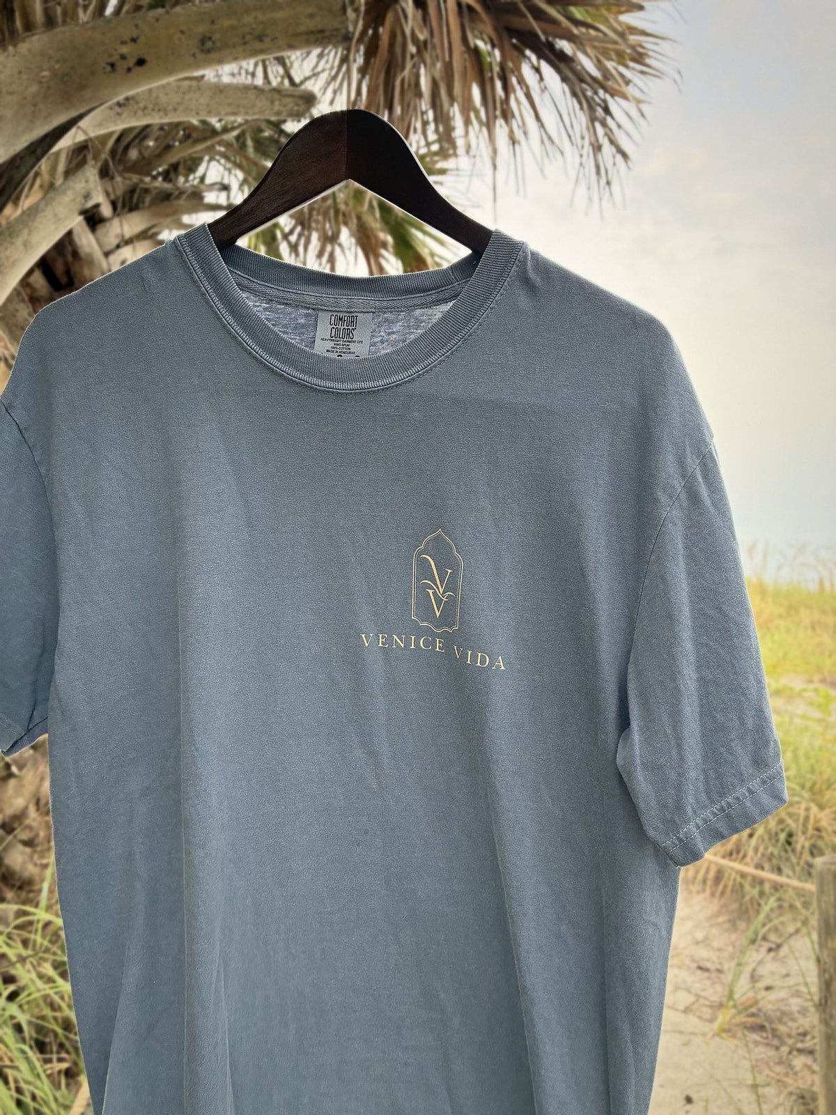 Close-up of the cream Venice Vida VV logo print on the Signature Gulf Tee, a garment-dyed Comfort Colors tee