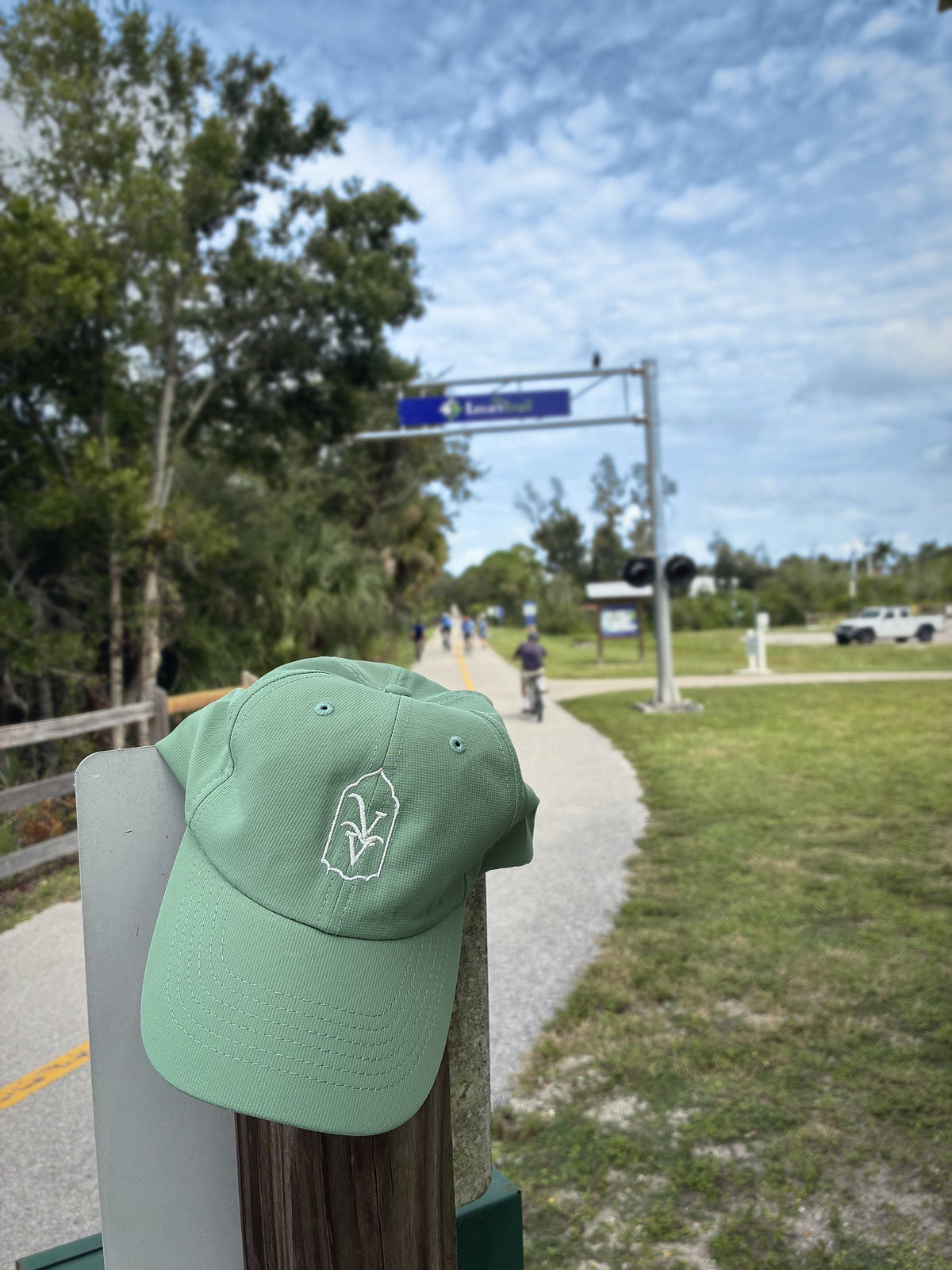 Venice Vida Banyan Hat in Laurel Green on a post along the Legacy Trail in Venice, Florida