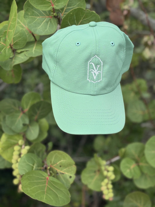 Venice Vida Banyan Hat in Laurel Green with white embroidered VV mark among sea grape leaves