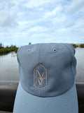 Venice Vida Signature Hat in Breaker Blue with embroidered VV mark, by the water in Venice, Florida